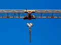 yellow steel truss crane boom closeup with hoist and pulley. heavy construction machine