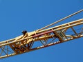 yellow steel truss crane boom detail under blue sky Royalty Free Stock Photo