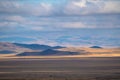 Yellow steppe and dark mountains at sunset. Autumn landscapes near Kosh-Agach, Altai, Russia Royalty Free Stock Photo