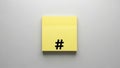 Yellow sticky note with black hashtag symbol on neutral background Royalty Free Stock Photo