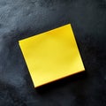 Yellow sticky note on dark surface Royalty Free Stock Photo
