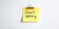 Yellow Sticky Note With Encouraging Don t Worry Message. Isolated on White Background. Royalty Free Stock Photo