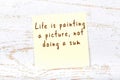 Yellow sticky note with handwritten motivational quote