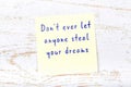 Yellow sticky note with handwritten motivational quote