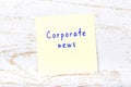 Yellow sticky note with handwritten text corporate news Royalty Free Stock Photo