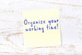 Yellow sticky note with handwritten text organize your working time