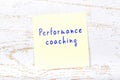 Yellow sticky note with handwritten text performance coaching Royalty Free Stock Photo