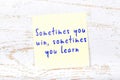 Yellow sticky note with handwritten text sometimes you win sometimes you learn