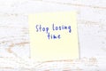 Yellow sticky note with handwritten text stop losing time Royalty Free Stock Photo