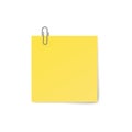 Yellow sticky note with paper clip isolated on white background. Royalty Free Stock Photo