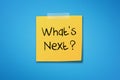 Yellow sticky note paper with what`s next on blue background Royalty Free Stock Photo