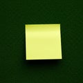 A yellow sticky note is positioned centrally on a textured dark green surface. The Royalty Free Stock Photo