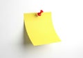 Yellow sticky note with red thumbtack on white background isolated Royalty Free Stock Photo