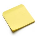 Yellow sticky note on white surface isolated on white background Royalty Free Stock Photo