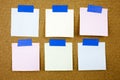 A yellow sticky note writing, caption, inscription Cork board with six blank colorful sticky notes. Royalty Free Stock Photo