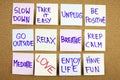 A yellow sticky note writing, caption, inscription Slow down, take ir easy be positive go outside relax breathe keep