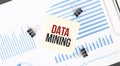 Yellow sticky notes with text DATA MINING on the white office desk. Business concept Royalty Free Stock Photo