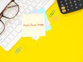 Yellow sticky paper Write a handwritten message `work from home` on keyboard and calculator, eyesglass, over yellow workplace de