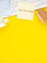 Yellow sticky paper Write a handwritten message `work from home` on keyboard with hand sanitizer alcohol gel, medical face mask,