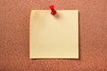 Yellow sticky post note pinned cork board background Royalty Free Stock Photo