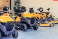 A row of sit on lawn mowers