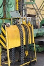 Yellow storage rack for chain slings for lifting loads on a crane Royalty Free Stock Photo