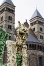 Yellow strange statue with old european church as background