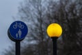 Yellow street lamp and road sign - Separate lanes for pedestrians and cyclists Royalty Free Stock Photo