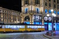 yellow streetcar moving by night in the center city in milan city in italy in europe
