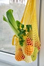 Yellow string shopping bag with vegetables and fruits Royalty Free Stock Photo