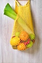 Yellow string shopping bag with vegetables and fruits Royalty Free Stock Photo