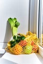 Yellow string shopping bag with vegetables and fruits Royalty Free Stock Photo