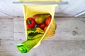 Yellow string shopping bag with vegetables and fruits Royalty Free Stock Photo