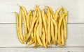 Yellow string wax beans on white boards. Tabletop view.