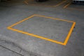 A rectangular frame yellow strip line on the grey floor