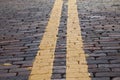 Yellow stripe on brick street Royalty Free Stock Photo