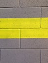Yellow stripe on cinderblock wall