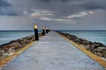 Yellow stripes along the sides of a jetty leading out to the water early morning in Aruba Royalty Free Stock Photo