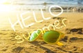 Yellow style sunglasses on sandy beach in summer. Sun and sea waves in the background, depth of field focus blur Royalty Free Stock Photo