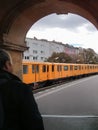 Yellow subway train through an arch in Berlin, Germany