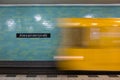 Yellow subway train in motion on Berlin Alexanderplatz underground station.