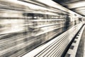 Yellow subway train speeding up on a city station. Business and Royalty Free Stock Photo