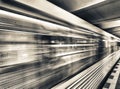 Yellow subway train speeding up on a city station. Business and Royalty Free Stock Photo