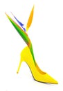 Yellow suede stiletto heel shoe and bird of paradise strelitzia reginae on white background Royalty Free Stock Photo