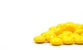 Yellow sugar coated tablets pills on white background