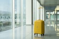 Yellow suitcase in airport terminal, lonely luggage in empty departure lounge or waiting area Royalty Free Stock Photo