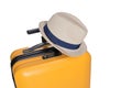 yellow suitcase with a combination lock with numbers 777 on it..Summer time -Travel bag and straw hat on top Royalty Free Stock Photo