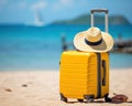 yellow suitcase hat and sunglasses on the beach.