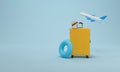 Yellow suitcase packed, float, hat and airplane on blue background for summer vacation