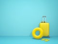 Yellow suitcase, sunglasses, swimming ring and flip flops on blue background